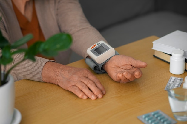 Foto Ältere person misst ihren blutdruck mit einem tensiometer