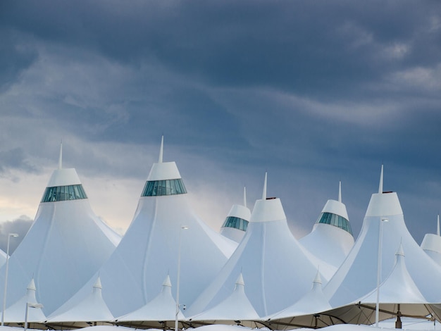 Aeroporto Internacional de Denver conhecido por seu telhado pontiagudo. O design do telhado está refletindo montanhas cobertas de neve.