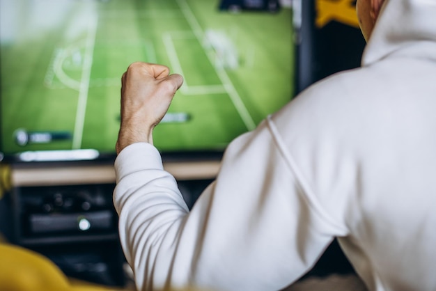 Foto aficionado al fútbol hombre viendo el partido en un televisor