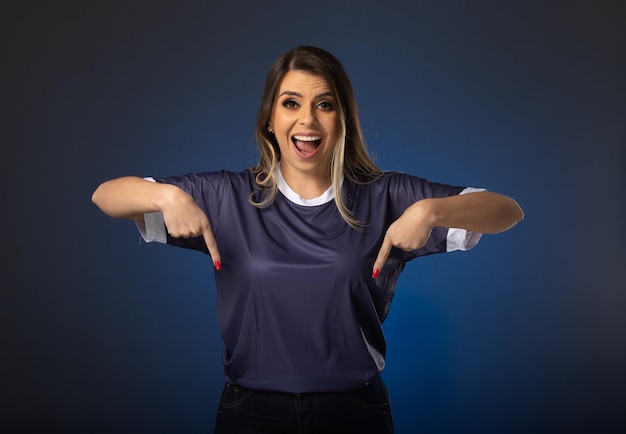 Aficionado al fútbol mujer animando a su club favorito y al equipo de fondo azul de la copa mundial