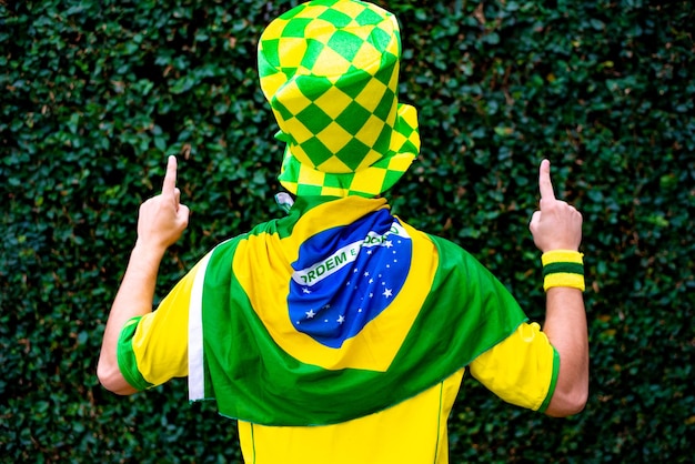 Foto un aficionado brasileño celebra y anima al equipo nacional de brasil en la copa del mundo