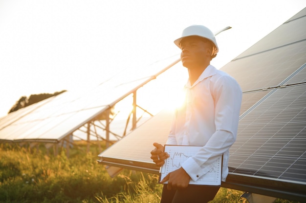 Afrikanisch-amerikanischer Techniker überprüft die Wartung der Solarmodule Schwarzer Ingenieur in der Solarstation