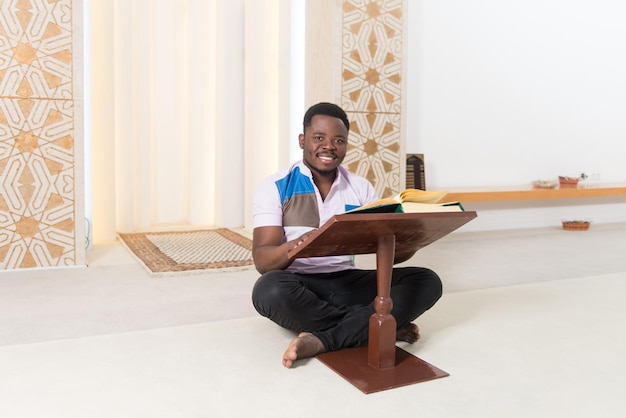 Afrikanischer muslimischer Mann liest den Koran