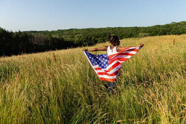 Afroamerikanerin in amerikanische Flagge gehüllt