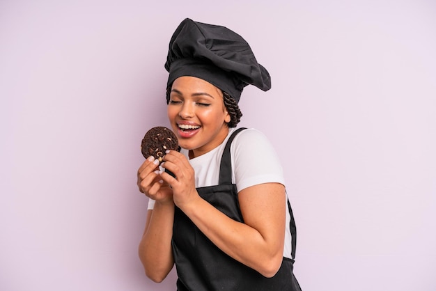 Afroschwarze Köchin mit Zöpfen und Plätzchen backen