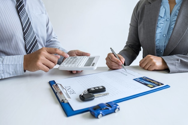 Foto agente de bienes raíces gerente que mantiene el formulario de contrato de alquiler a la clienta para decidir firmar el acuerdo, alquilar considerando el seguro del automóvil