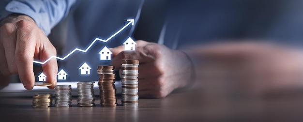 Agente de bienes raíces que muestra la casa y la pila de monedas Gráfico de bienes raíces Crecimiento del mercado de la casa