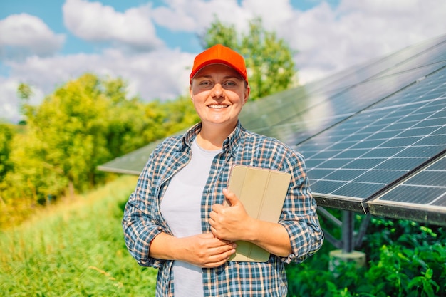 La agricultora está usando una tableta inteligente para investigar sobre el panel solar fotovoltaico en el jardín Agricultura de tecnología verde Energía renovable Energía natural Estilo de vida ecológico