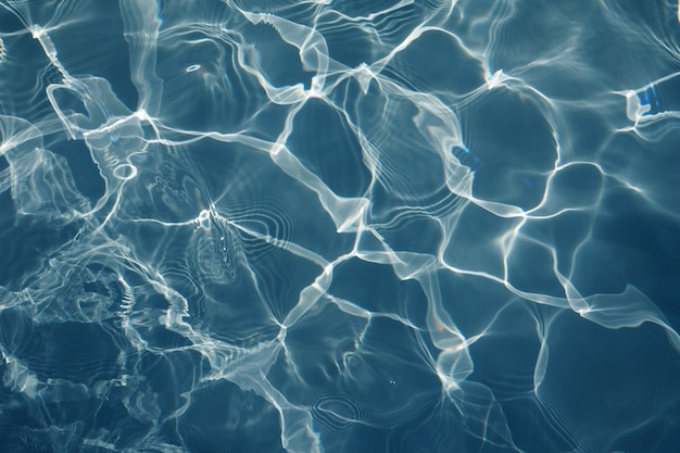 Agua azul en la piscina de fondo, primer plano