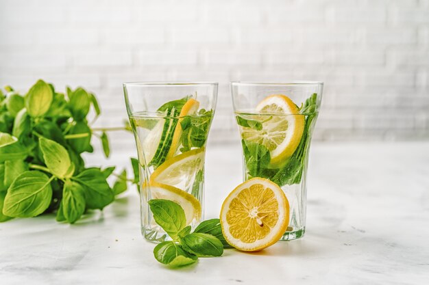 Água com infusão de desintoxicação com pepino e limão no fundo branco