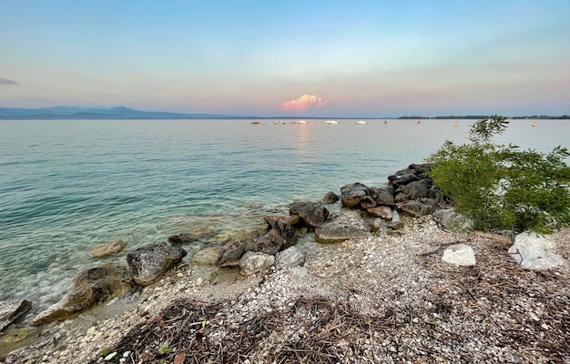 Água do lago garda na itália cercada por montanhas no verão