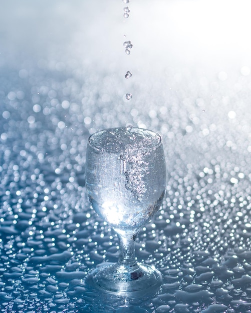 Un agua fría clara y fresca se vierte en un vaso