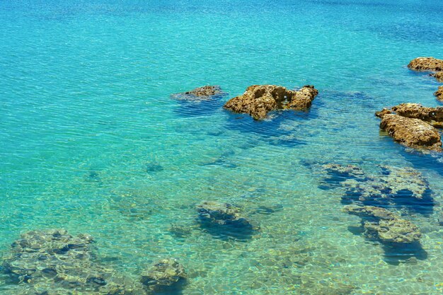 Agua de mar verde azul claro con rocas hermoso fondo de naturaleza