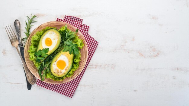 Aguacate al horno con huevo Comida saludable Sobre un fondo de madera Vista superior Espacio de copia