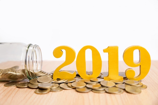 Ahorro año nuevo Concept.Word 2019 puesto en monedas y botellas de vidrio con monedas dentro