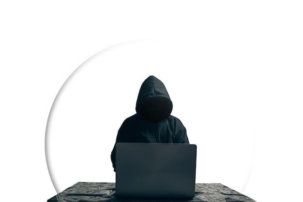 Foto aislado de un joven hacker desconocido sentado jugando portátil con mucho dinero