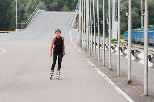 Aktive Rollschuh-Vorderansicht der Seniorenfrau im Stadion