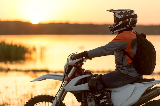 Foto aktiver mann der seitenansicht, der motorradfahrt genießt