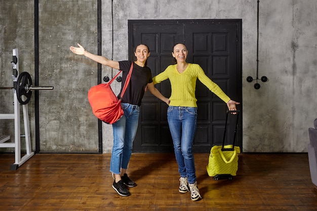 Al volver a casa después de las vacaciones, dos esbeltas mujeres maduras saludan a sus seres queridos en casa