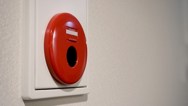 Foto alarma de incendio de emergencia o alerta o equipo de advertencia de campana de color rojo sobre fondo blanco en la pared del edificio para seguridad en japón.