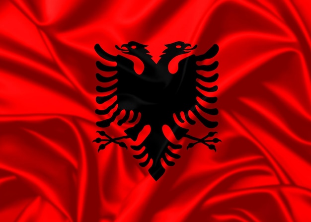 Foto albania ondeando la bandera cerca de fondo de textura satinada