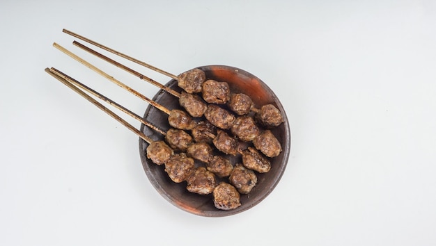 Albóndigas a la parrilla bakso bakar aislado sobre fondo blanco. Comida tradicional de Java Oriental Indonesia