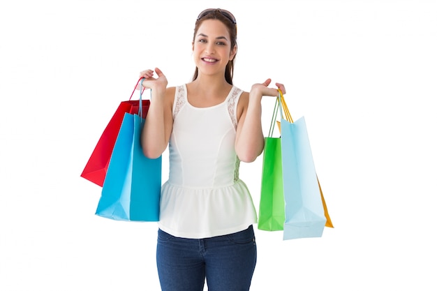 Alegre cabello castaño con bolsas de compras