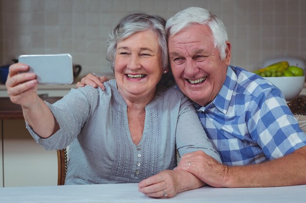 Foto alegre casal sênior tomando selfie