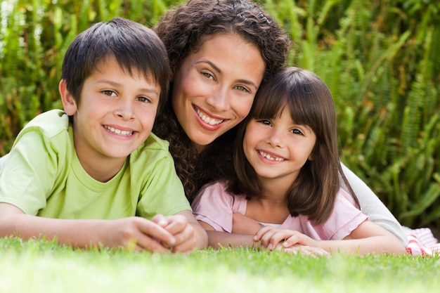 Alegre familia acostada en el jardín en casa