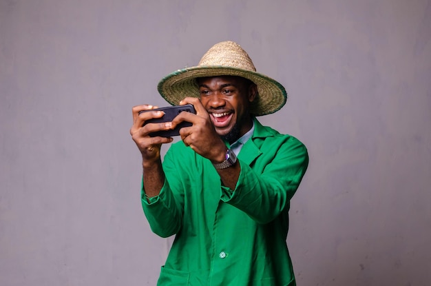 Alegre hombre afroamericano con camisa blanca usando una aplicación de teléfono móvil