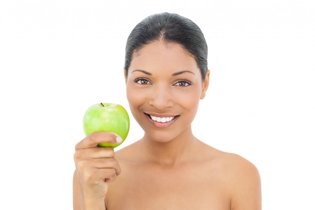 Alegre modelo de pelo negro con manzana verde