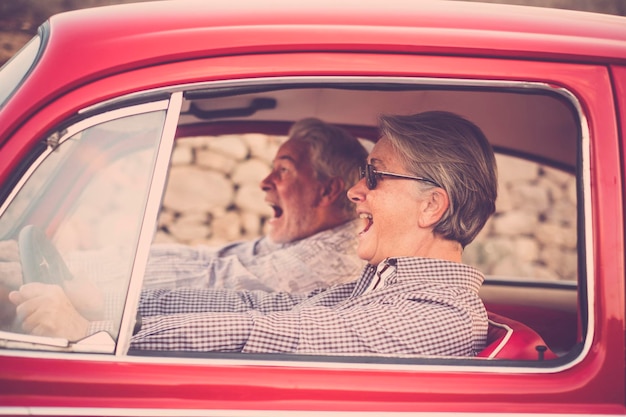 Una alegre pareja de ancianos viajando en coche