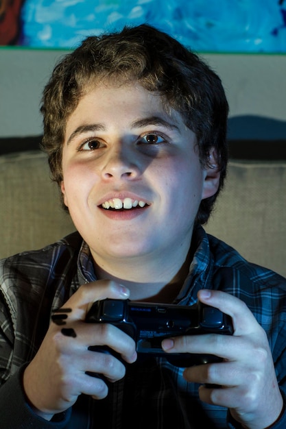 Alegría. Estilo de vida adolescente. niño con joystick jugando juegos de computadora en casa.