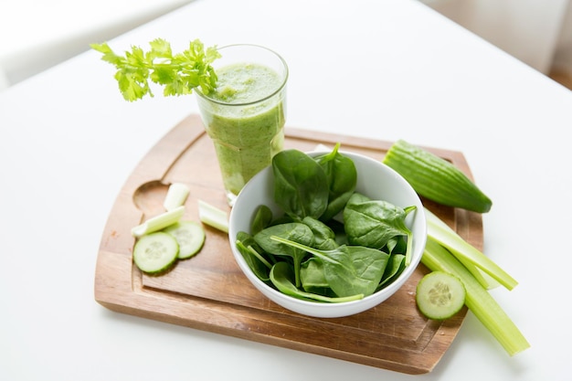 alimentação saudável, alimentos orgânicos e conceito de dieta - close-up de suco verde fresco com aipo na mesa de madeira