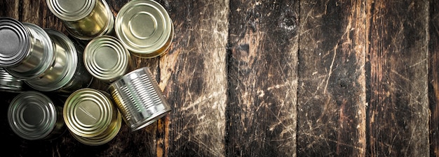 Alimentos en latas. Sobre un fondo de madera.