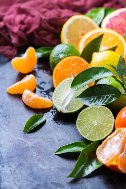 Alimentos saludables dieta nutrición naturaleza concepto cítricos vitamina fondo naranja pomelo mandarina lima limón con hojas en una mesa negra grunge