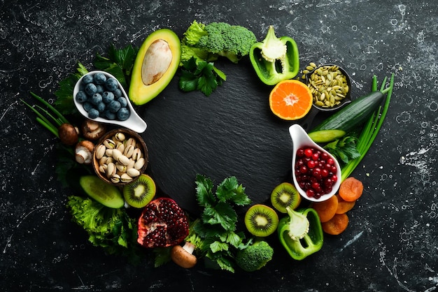 Alimentos saludables Verduras y frutas Sobre un fondo de madera negra Vista superior Espacio de copia