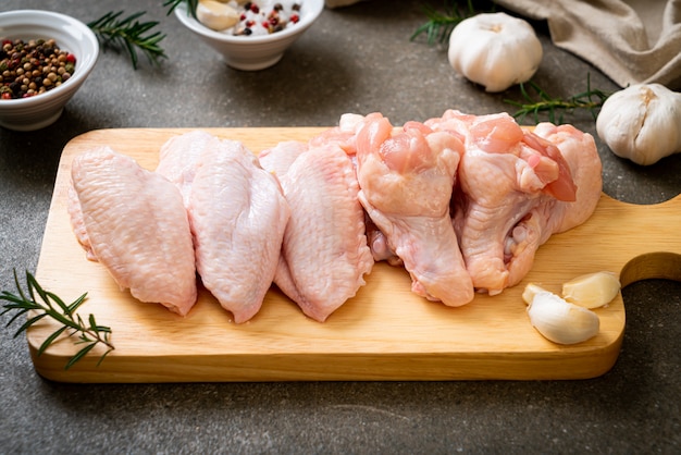 alitas de pollo crudas frescas sobre tabla de madera