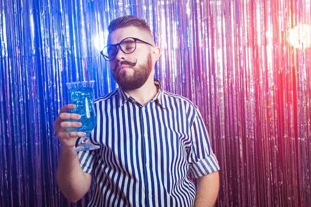 Alkoholismus, Spaß und Narrenkonzept - Betrunkener Kerl auf Party in einem Nachtclub.