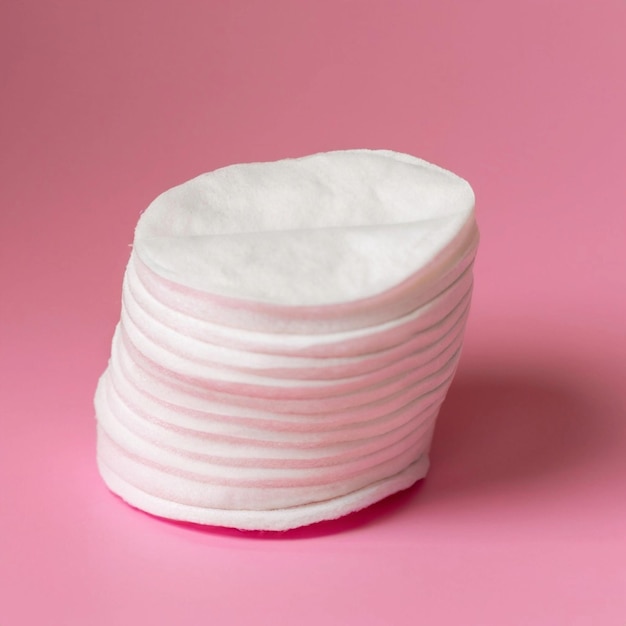 Almofadas de algodón cosméticas una pila de almohadas de algudón en un delicado fondo rosa spa de primer plano
