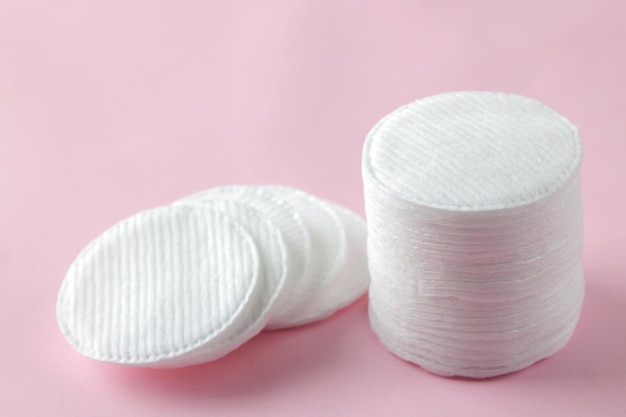 Almohadillas de algodón cosmético. Una pila de almohadillas de algodón sobre un delicado fondo rosa. spa. de cerca.