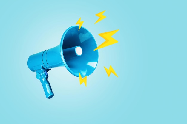 Altavoz azul creativo con relámpagos amarillos sobre un fondo azul Atención a la idea creativa Noticias urgentes Publicidad y mensaje de tráfico relámpago
