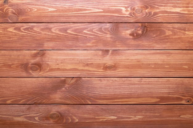 Alte braune holzplanken, holzstruktur. schreibtisch gestreifte oberfläche. natürliche farbe. verwittertes holz, bretthintergrund. vintage tür, zaun, latten.