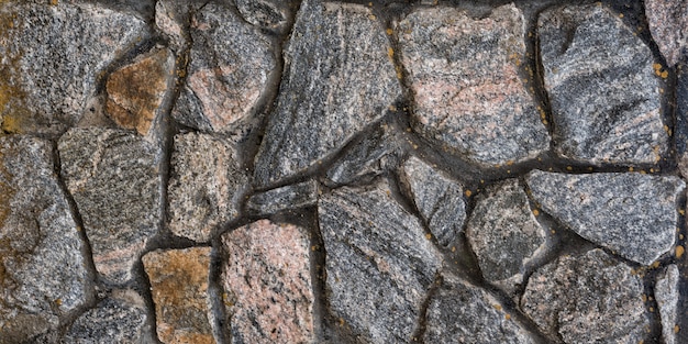 Alte Mauer aus Naturstein. Abstrakter Hintergrund