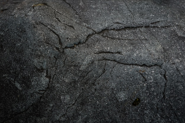 Alte raue schwarze Granitoberfläche