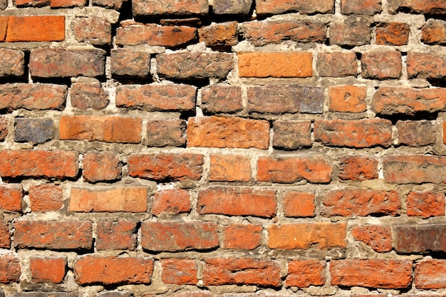 Alte Weinlesewand der orange Ziegelsteine. Abstrakter architektonischer Hintergrund