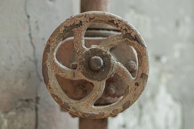Altes rostiges Ventil auf einem alten rostigen Rohr in Nahaufnahme