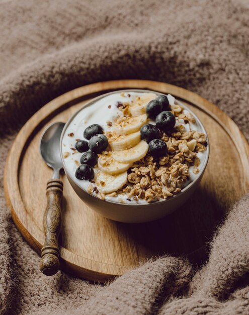 Foto alto ángulo de desayuno en la cama con cereales y plátano