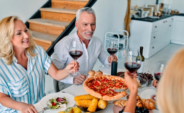 Altos amigos cenando en casa