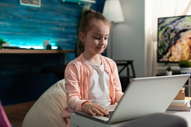 Alumno inteligente que trabaja en la tarea de literatura navegando por información educativa en la computadora usando la plataforma elearning. Niño estudiando para la lección académica en línea. Educación a distancia